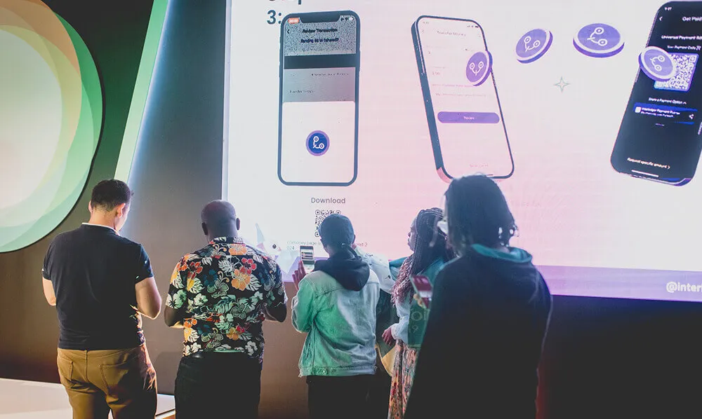 Attendees interacting with a live demo at the 2024 Summit