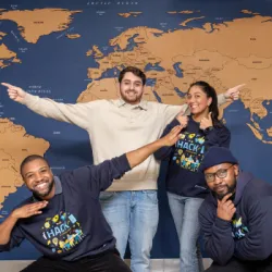 Four members of a winning hackathon team standing together and smiling.